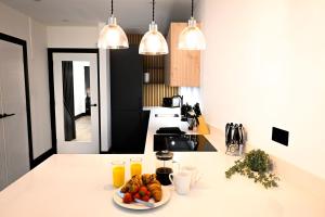 a kitchen with a plate of fruit on a counter at Laurie Grove in London
