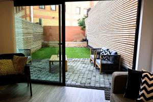 a room with a sliding glass door with a patio at Laurie Grove in London
