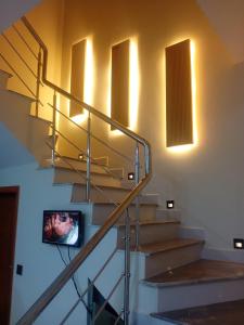 a set of stairs with a tv on the wall at Bahria town karachi Volka Guest House in Karachi