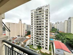 a view of a tall white building from a balcony at Flat Moema Apart La Maison D´Stan 02 DTS - UH82 in São Paulo