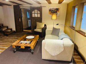 a living room with a couch and a coffee table at Studiowohnung im preisgekrönten Denkmal in Groß-Umstadt in Groß-Umstadt +12 photos