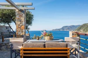 a table and chairs with a view of the ocean at Casa Milos Aegean Suites in Alonnisos