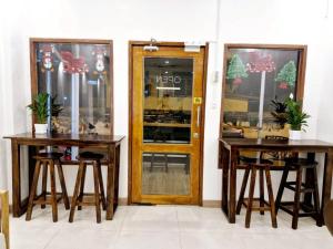 a restaurant with two tables and a glass door at MaMa Hostel CNX in Chiang Mai