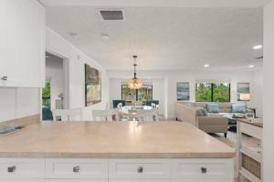 a kitchen and living room with a couch and a table at Blind Pass #E209 in Sanibel