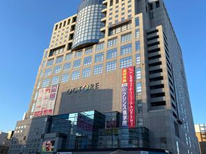 a tall building with signs on the side of it at Hachioji House 206 Apartment in Hachioji
