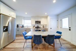 a kitchen with a table and chairs and a refrigerator at Stylish 4BR Home - Modern & Bright Interior in Charlotte