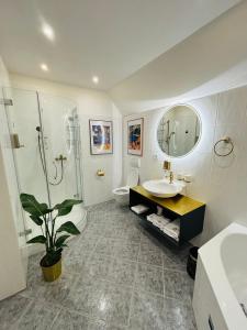 a bathroom with a sink and a shower and a toilet at CASA Salzburg in Salzburg