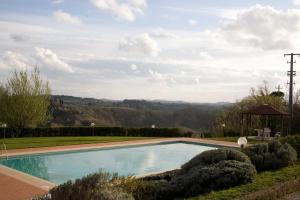 a pool in the middle of a grassy area at Agriturismo Marrucola in San Miniato