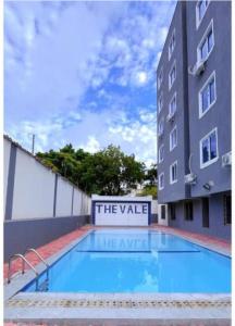 a large swimming pool in front of a building at Bella luxury homes in Mombasa