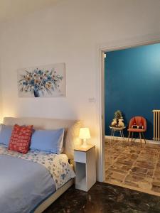 a bedroom with a bed and a table with a chair at Fiori e Frutti Guest Home in Almese