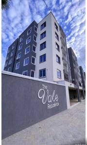 a tall building with a sign in front of it at Bella luxury homes in Mombasa
