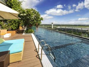 a swimming pool on top of a building at Ibis Saigon Airport in Ho Chi Minh City