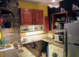 a kitchen with a refrigerator and a stove top oven at Condo Studio Paradise Beach in Alexandria +83 photos