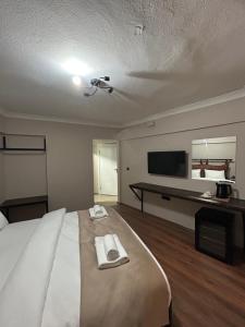 a hotel room with a large bed and a television at Pera Line Yalova in Yalova