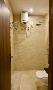 a bathroom with a toilet and a shower at Sufi stay in Rishīkesh +31 photos