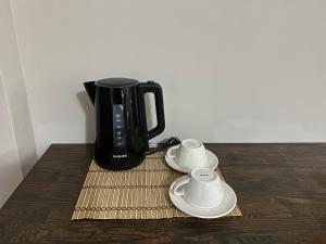 a black coffee pot sitting on top of a wooden table at Pera Line Yalova in Yalova