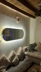 a living room with a couch and a mirror at Fresco in Dahab