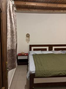 a bedroom with a bed with a green blanket at Fresco in Dahab