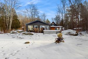 a house in the snow in front at Art Rocks in Stowe