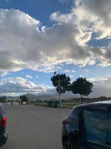a car parked in a parking lot under a cloudy sky at bel appartement à Martil in Martil