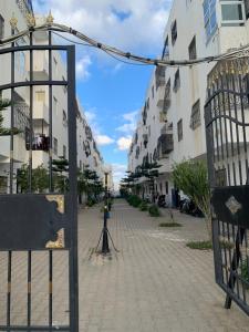 an empty street with buildings and a street light at bel appartement à Martil in Martil