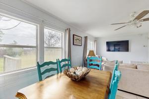 a living room with a table and chairs and a couch at The Saltbox in Padre Island