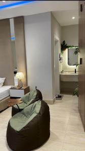a living room with a bean bag chair and a bed at Mfj Marbella Stay دخول ذاتي بموقف خاص وإطلالة مسبح in Al Khobar +24 photos