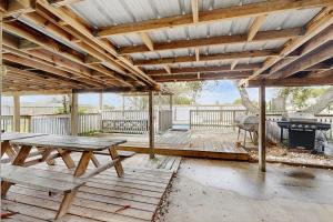 a patio with a picnic table and a grill at The Saltbox in Padre Island