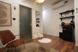a room with a green door and a table and chairs at One Apartments TLV in Tel Aviv +66 photos