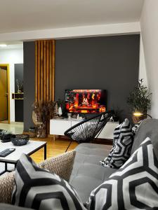 un soggiorno con divano e TV a schermo piatto di Apartman Riva Parking Garaža a Kraljevo