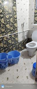 a bathroom with a toilet and three blue buckets at Omkar Homestay Adgaon Beach Sea View Next to Diveagar 2 in Adgaon
