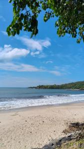 a beach with the ocean in the background at Omkar Homestay Adgaon Beach Sea View Next to Diveagar 2 in Adgaon