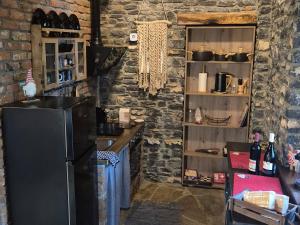 a kitchen with a black refrigerator and a counter at Black Rock Agria in Agria
