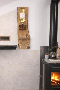 a fireplace with a candle next to a stove at Bellavista in Coazze +17 photos
