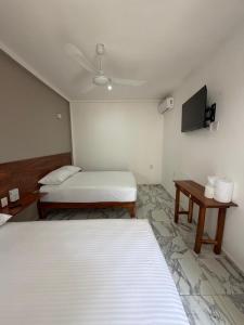 En eller flere senge i et værelse på Hotel centrico tulum