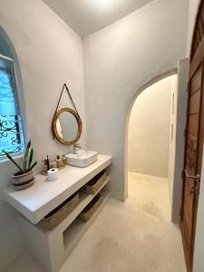 een badkamer met een wastafel en een spiegel bij Natural living eco resort in Malindi