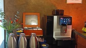 a kitchen with a refrigerator and a microwave and vases at Plitvice Falls Cottage - Luxury rooms & Dinner in Plitvica selo