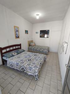 En eller flere senge i et værelse på Suite Praias Penha SC + 27 billeder