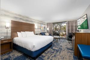 a hotel room with a bed and a television at MCM Elegante Hotel in Odessa +29 photos