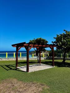 a wooden pavilion in a park next to the ocean at D O M A I N E - D E - L' A N S E - P I S T O L E T - Proche Grande Vigie, Vue Unique in Anse-Bertrand +31 photos
