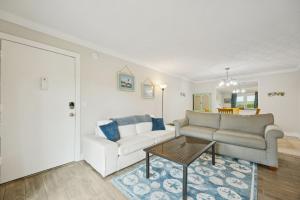 a living room with a couch and a table at Chill by The Shores - Pet Friendly - Fernandina Beach in Fernandina Beach
