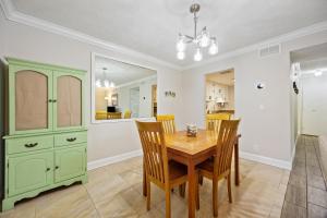 a dining room with a green cabinet and a table at Chill by The Shores - Pet Friendly - Fernandina Beach in Fernandina Beach