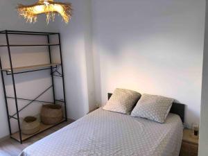 a bedroom with a bed and a shelf at LES BATTERIES bord de mer in Collioure
