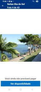 a screenshot of a cell phone with a picture of a beach at Pousada Ilha do Sol in Cananéia
