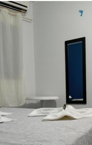 a room with a bed with a blue sign on it at Pousada Ilha do Sol in Cananéia