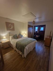 En eller flere senge i et værelse på Mill Lane Farm Holiday Cottages