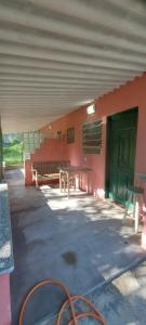 a patio with a table and benches in a building at Hostel33 brazil praia in Caraguatatuba +3 photos