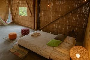 a bedroom with a bed in a wooden room at Glamping Due Amici Restobar in Palomino
