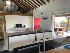 a kitchen with a sink and a faucet at Villa fleurs d'Antalia in Anse-Bertrand