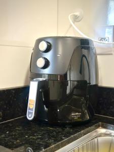 een broodrooster bovenop een aanrecht bij Apartamento Palmeira Essencial in Formosa